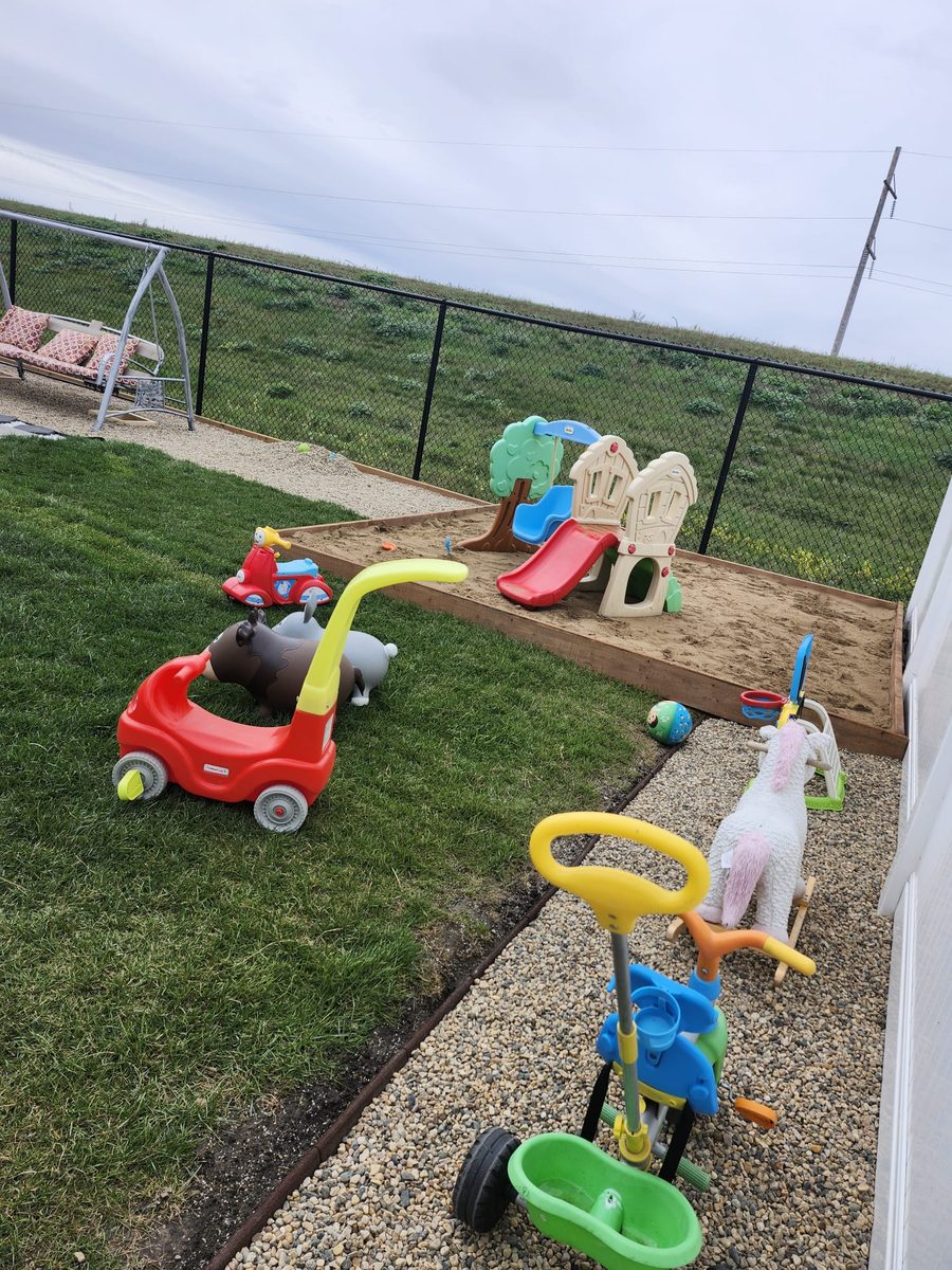 Outdoor sandbox and play area at Mini Castle Daycare
