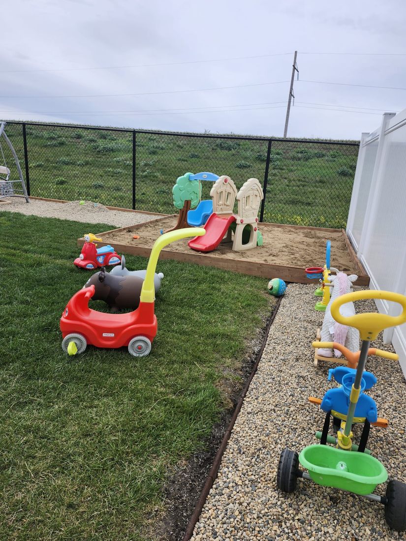 Outdoor sandbox and play area with a slide
